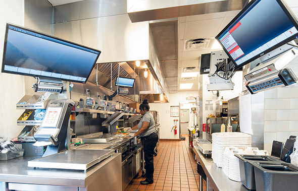 Krystal's kitchen interior, which includes a single, higher-capacity cook line and a significantly wider drive-thru window and expo station.