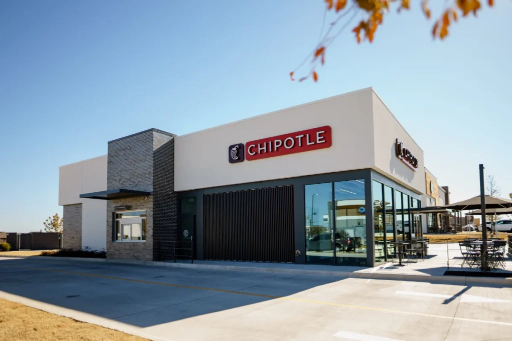A side view of a Chipotle restaurant and its drive-thru window.