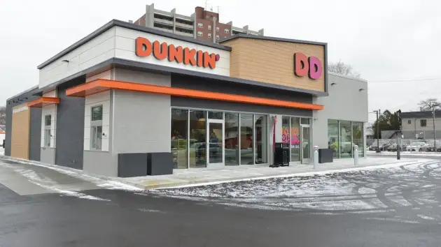 An exterior view of a Dunkin' restaurant in winter.