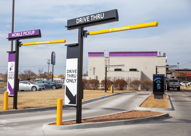 A shot of two Taco Bell drive-thru lanes, one of which is for regular drive-thru orders, and one for mobile pickup orders.