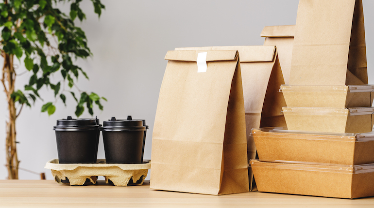 Various paper takeout food containers, pizza boxes, coffee cups, and paper bags.