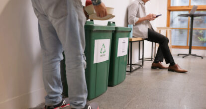 A guest at a restaurant recycling their waste.