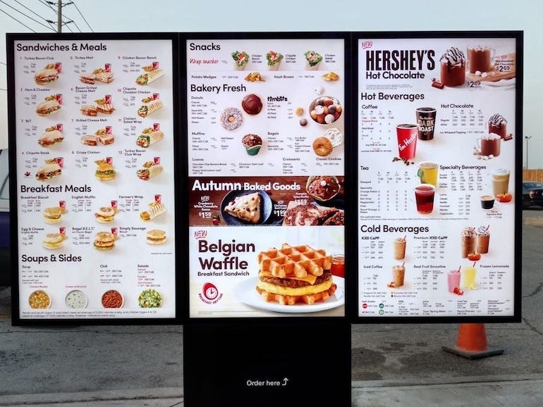 An image of a Tim Hortons drive-thru menu, including all its drink, sandwich, and bakery options.