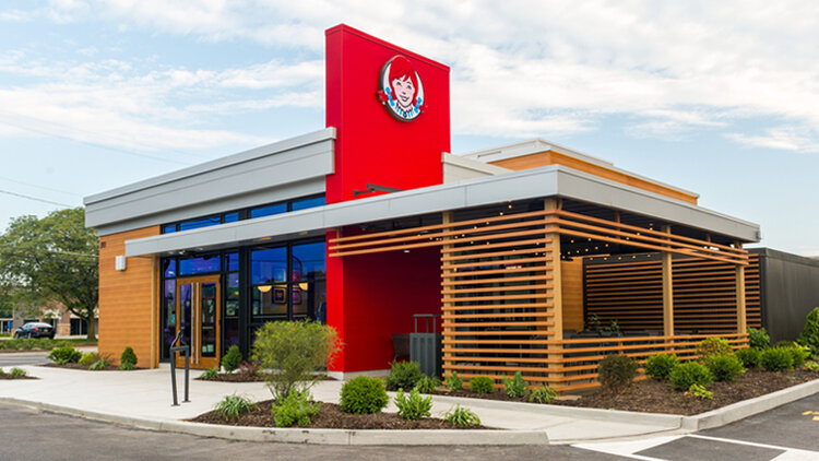 A modern Wendy's restaurant with wood slate detailing.