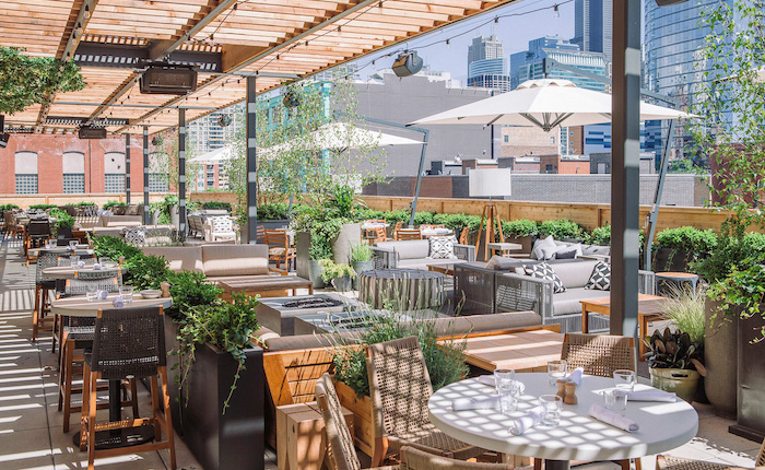 The rooftop patio of Chicago's Aba restaurant, which is covered in greenery.