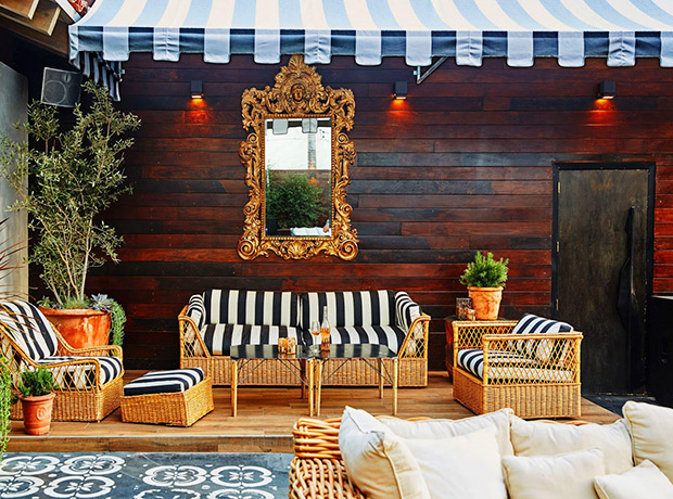 Striped patio cushions on rustic wicker chairs on the patio of Le Jardin's restaurant.