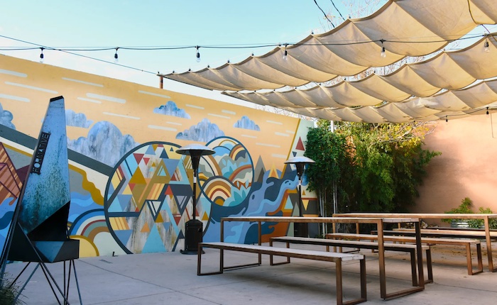 A colorful mural of mountains and geometric shapes on the patio of an Albuquerque, New Mexico-based coffee shop called Zendo.