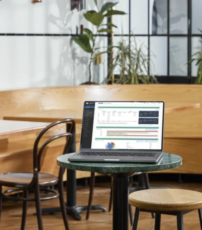 TouchBistro Profit Management on a laptop screen on a table in a restaurant