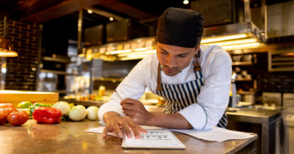 Chef doing paperwork in a restaurant.