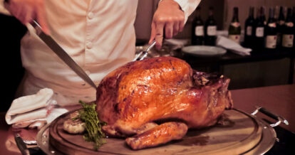 Chef cutting into a big turkey.