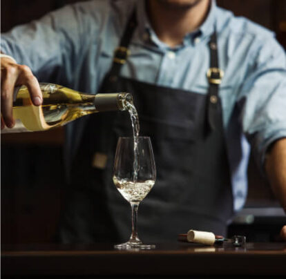 Server pouring wine