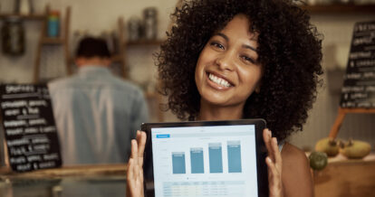 Woman holding a tablet showcasing a graph.