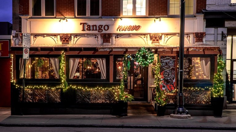 Exterior of Tango Nuevo restaurant decked out with Christmas decor.