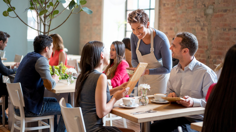 Restaurant server taking a man and woman's order.