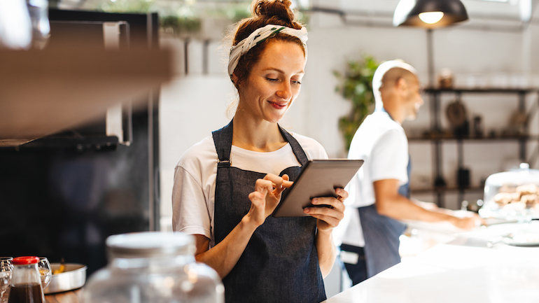 Restaurant server using a tablet.