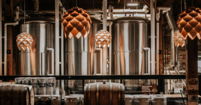 The beer tanks at 7 Hills Brewing Company, including hanging lights designed to look like the hops used to brew beer.