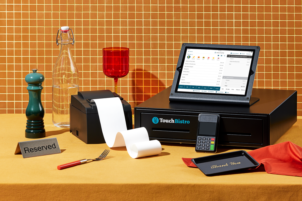 Full TouchBistro point of sale setup, including a receipt printer, payment terminal, and an iPad on a cash drawer.