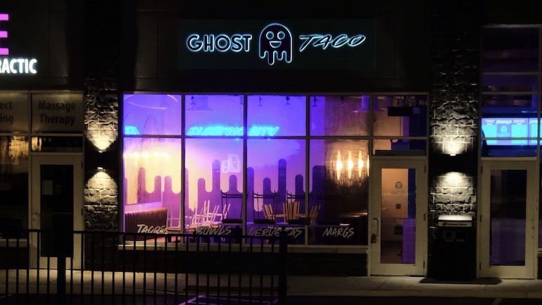 The front of the Ghost Taco restaurant at night.