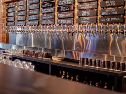 Row of beer taps at Sauced Taproom.