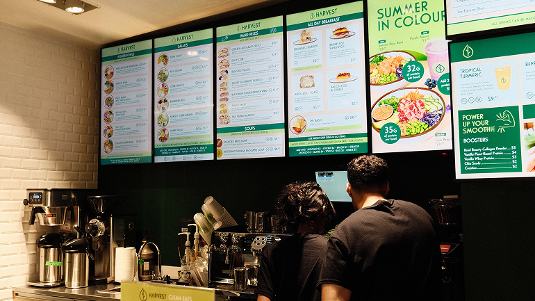 Harvest Clean Eats menu display board.